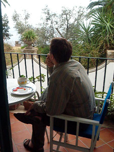Tom eating breakfast on the porch